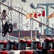 Evel Knievel performing a motorcycle stunt jump.