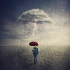 A person moving forward through strong wind and rain