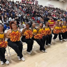 A high school pep rally with students and cheerleaders