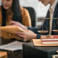 A paralegal reviewing legal papers at a desk