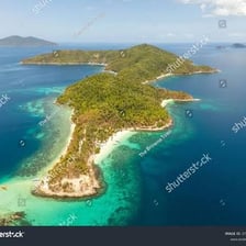 A small island surrounded by water near other islands.