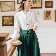 A blouse worn with a skirt