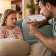 An adult admonishing a child to behave