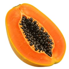 A halved papaya showing its black seeds