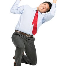 A person applying physical effort to push a heavy object.