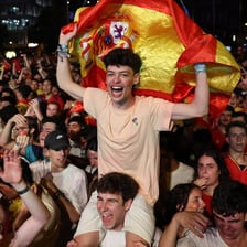 Fans cheering for Spain at a soccer match