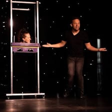 A magician performing a trick for an audience.
