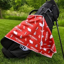A golf bag with a towel clipped to its side.