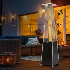 Tall patio heaters warming guests at an outdoor gathering.