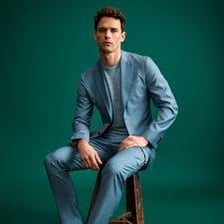 A stylishly dressed man wearing a neat suit.