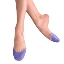Pointe shoes with protective toe pads beside them