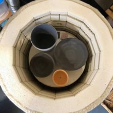 Pottery being fired inside a high-temperature kiln.