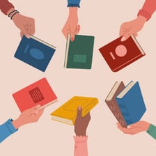 One person handing a book to another to borrow.