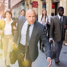 A person hurrying along a street.