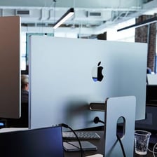 Mac computers displayed inside an Apple Store