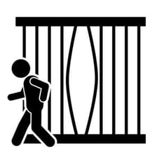A prisoner escaping from a jail cell.