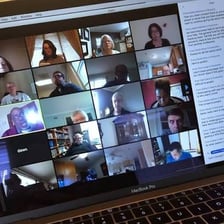 A laptop displaying a group video meeting