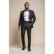 A man wearing a formal black tuxedo