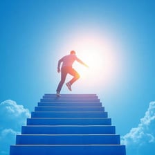 A person ascending toward a bright horizon, symbolizing progress and success.