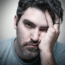 A person reacting with visible frustration or dismay