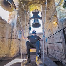 A large bell hanging in a tower