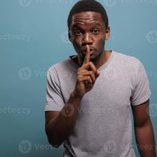 A person making a subtle gesture to communicate an indirect hint