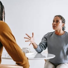 One person visibly provoking another during an argument.