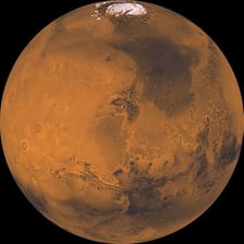 A reddish image of the planet Mars.