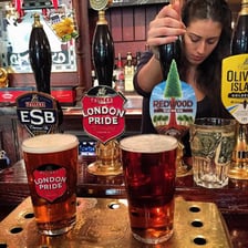 A pint of ale on a wooden pub table