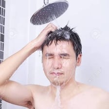 A person rinsing their hair under a shower.