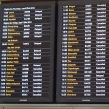 An airport departure board listing scheduled times