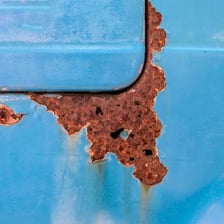 Reddish-brown rust covering a corroded metal surface