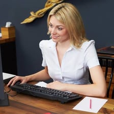 An assistant working at an office desk