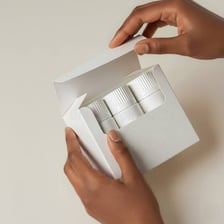 A person removing a new product from its box.