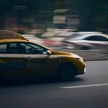 A taxi traveling along a city street