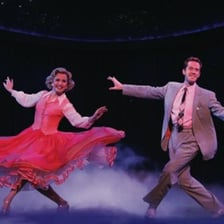 Two tap dancers performing together on a stage.