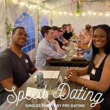 People talking across tables at a speed-dating event