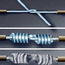 A soldering iron joining two metal surfaces.
