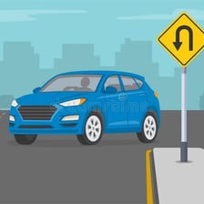 A car turning around in a U-shaped maneuver on a road