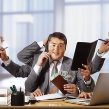 A person focused on work while other tasks wait.