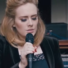 Adele performing onstage.