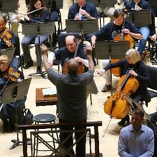 A featured musician performing during an orchestral concert