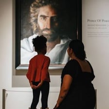 A person absorbed in admiration of a piece of artwork.