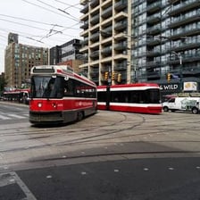 A tram traveling along urban street tracks.