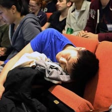 A person sleeping while seated in a lecture room