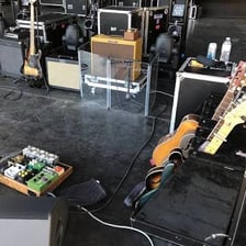 A guitar amplifier set up beside a performer at a concert.