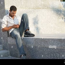A person seated or perched on a ledge