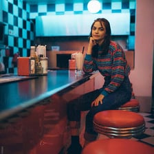 A person seated at a pub bar counter
