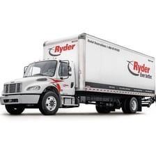 A yellow Ryder rental truck