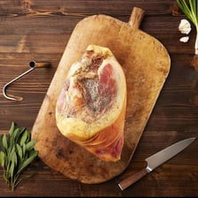 Slices of country ham arranged on a wooden serving board